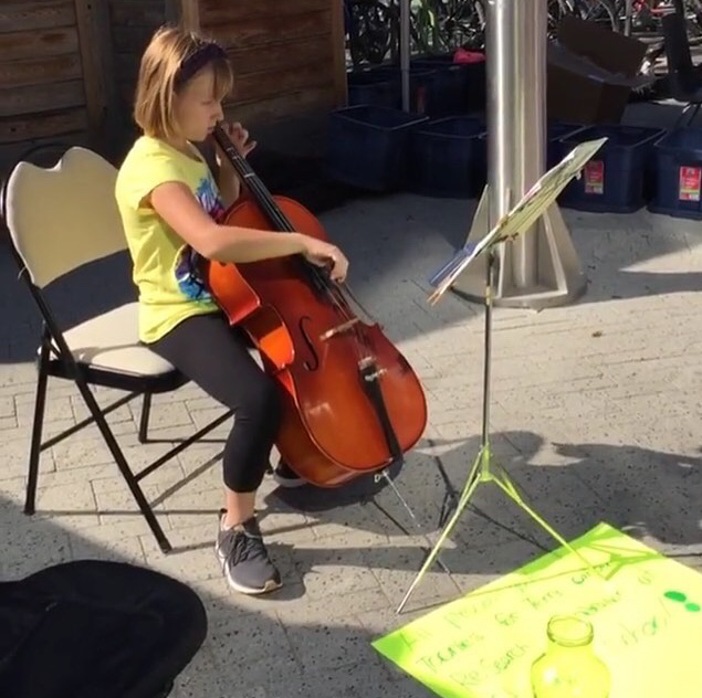 Girl sitting in chair playing the cello
